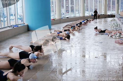 Image of happy children group  at swimming pool