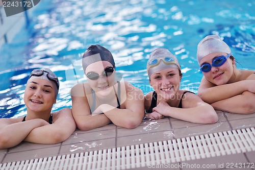 Image of happy teen group  at swimming pool