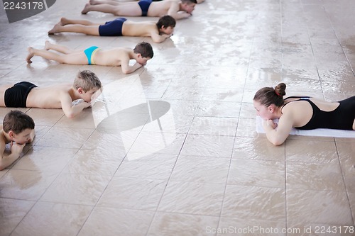 Image of happy children group  at swimming pool