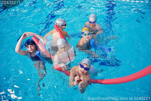 Image of happy children group  at swimming pool