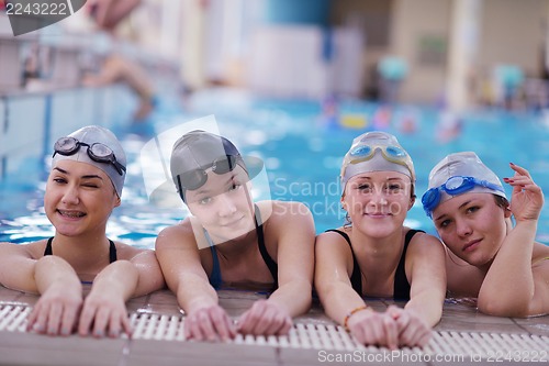 Image of happy teen group  at swimming pool