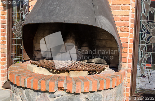 Image of retro hearth fireplace brick wall outdoor closeup 