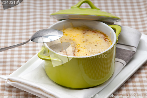 Image of onion soup with melted cheese and bread on top