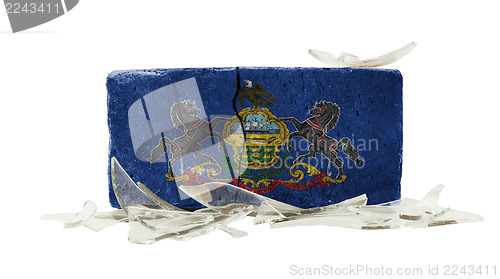 Image of Brick with broken glass, violence concept