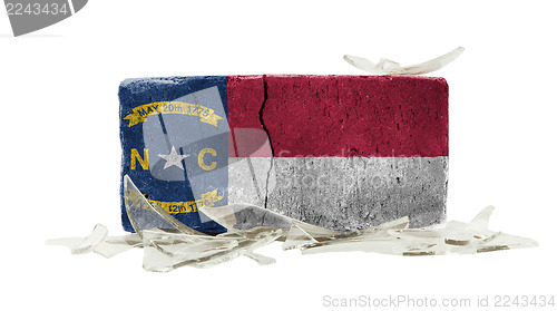 Image of Brick with broken glass, violence concept