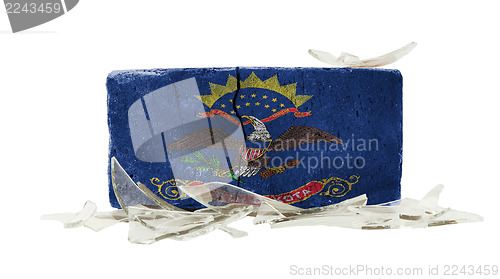 Image of Brick with broken glass, violence concept