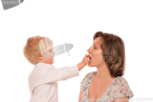 Image of Young boy giving a candy to her mother