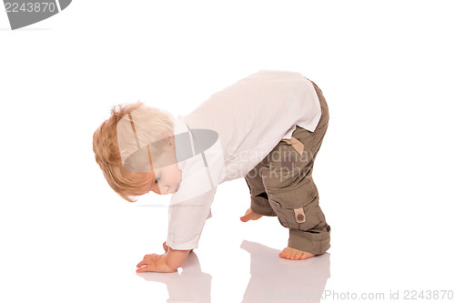 Image of Young boy learning to walk