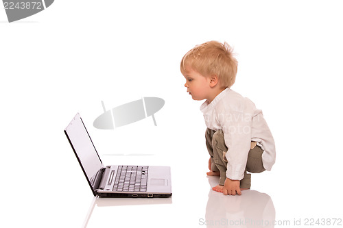 Image of Young boy looking at a laptop