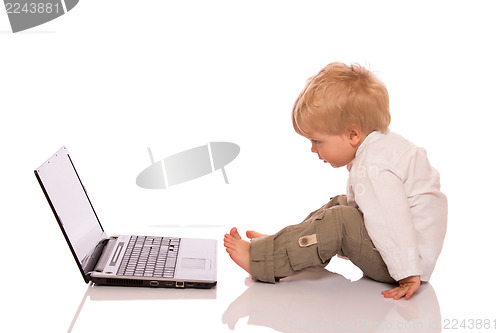 Image of Young boy looking at a laptop