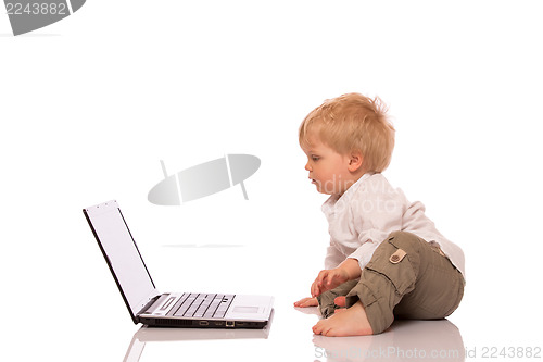 Image of Young boy looking at a laptop