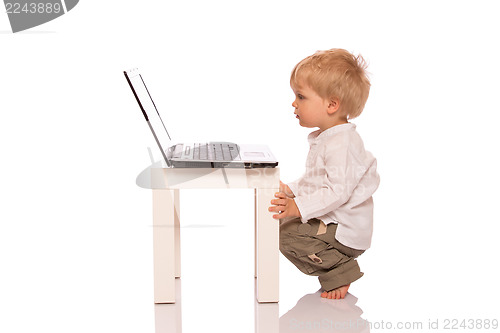 Image of Young boy looking at a laptop