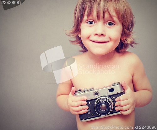 Image of boy with an old camera