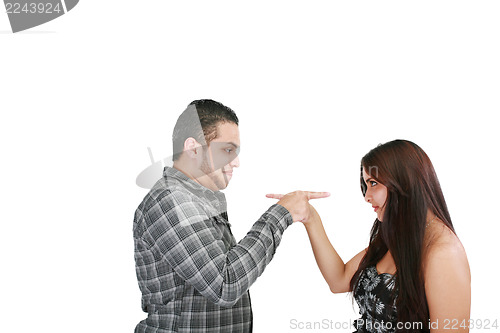 Image of Young couple pointing at each other against a white background 