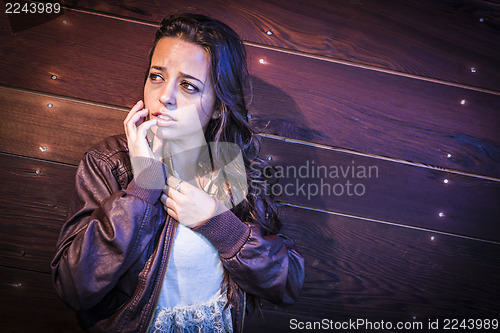 Image of Frightened Pretty Young Woman in Dark Walkway at Night