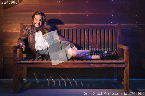 Image of Mixed Race Young Adult Woman Portrait Sitting on Wood Bench