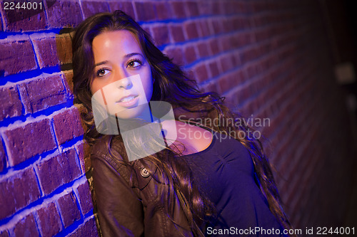 Image of Pretty Mixed Race Young Adult Woman Against a Brick Wall