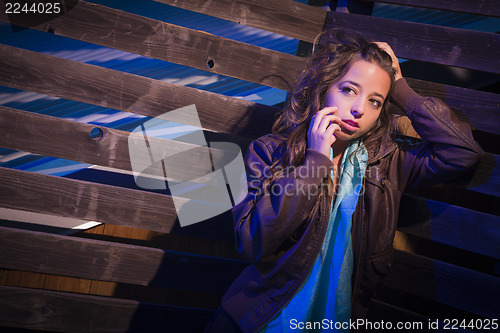 Image of Frightened Pretty Young Woman in Dark Walkway at Night