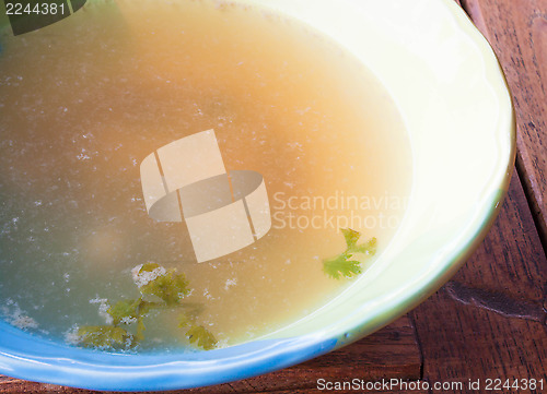 Image of Hot clear soup boiled from pork in ceramic bowl 