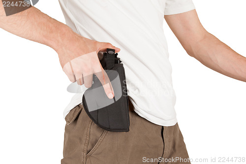 Image of Close-up of a man with his hand on a gun