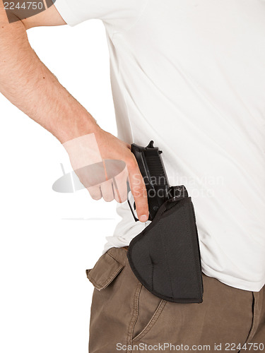 Image of Close-up of a man with his hand on a gun