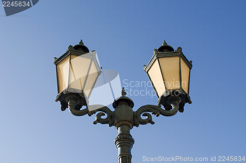 Image of iron lighting pole twin lamp background blue sky 