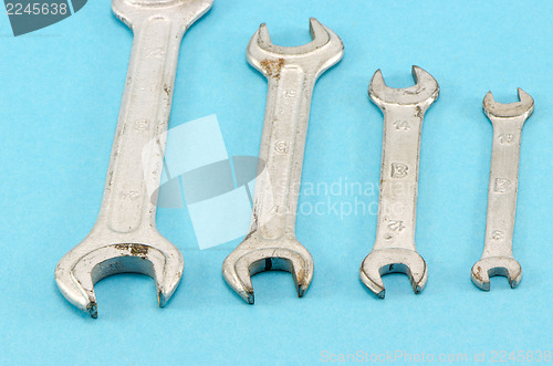 Image of set size hand wrench screw tools on blue 