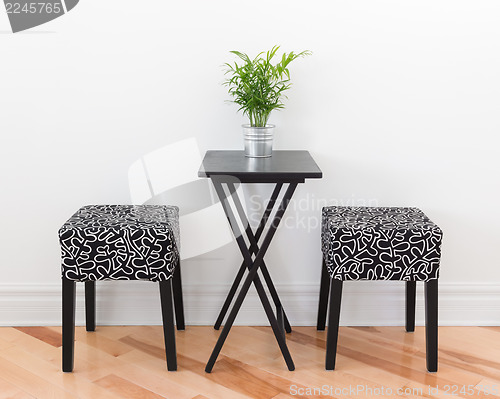 Image of Table for two decorated with green plant