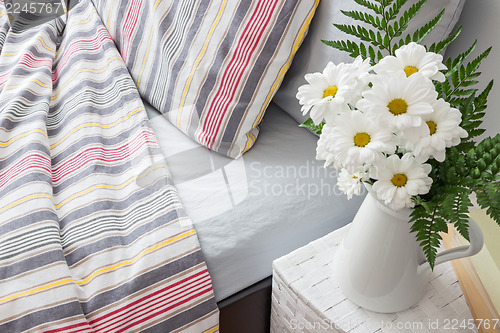 Image of Bright bedroom decorated with white flowers