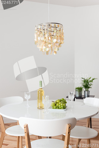 Image of Room with decorative chandelier and white round table