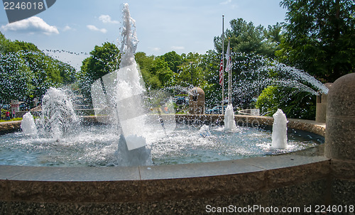 Image of Detail of an old classic style stone fountain with flowing water