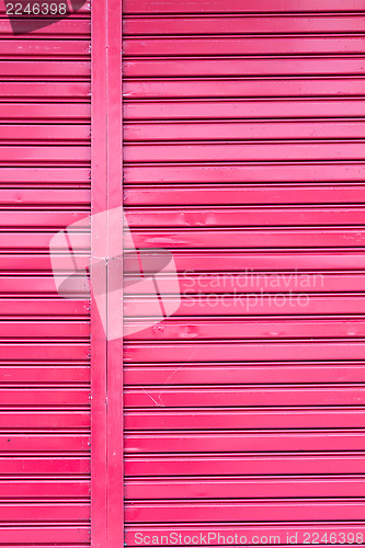 Image of Red roller metal entry door of apartment