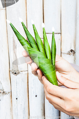 Image of Hand hold a part of rice offering 