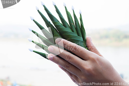 Image of Hands pay respect rice offering to natural surroundings