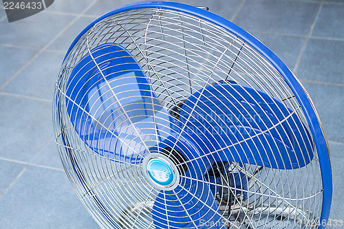 Image of Front of industrial fan on blue floor