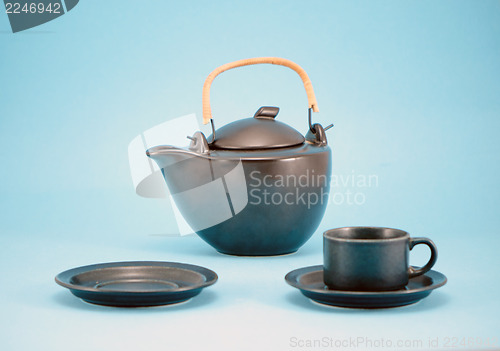 Image of empty dish saucer retro teapot cups blue hot tea 