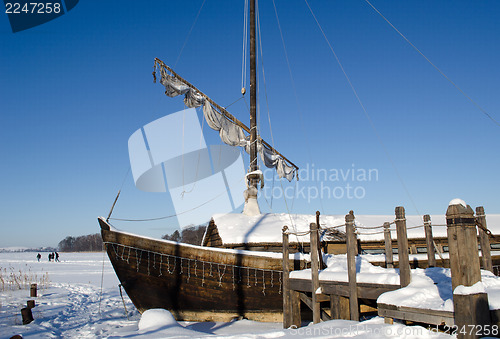 Image of retro wooden ship frozen lake ice sail people walk 