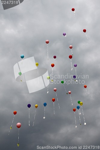 Image of color ballons on the grey sky 