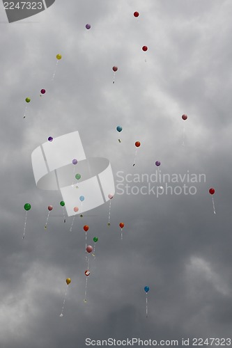 Image of color ballons on the grey sky 