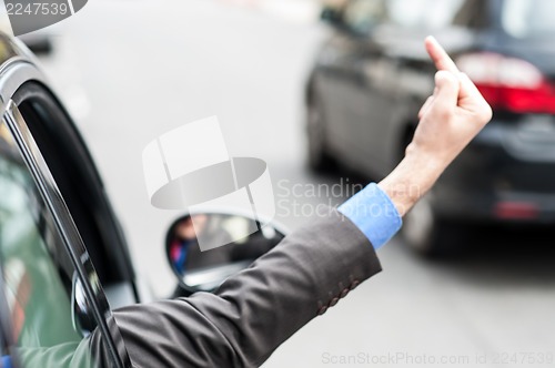 Image of Man showing middle finger from car window