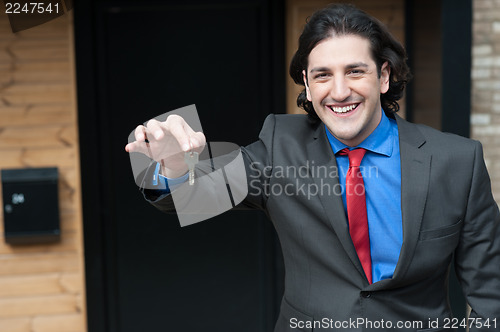 Image of Corporate male offering you office key