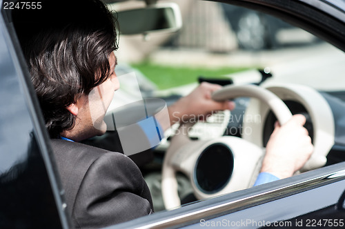 Image of Businessman driving his luxury dream car