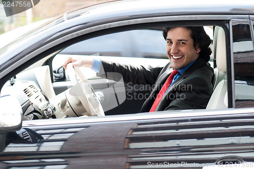 Image of Corporate man driving his car
