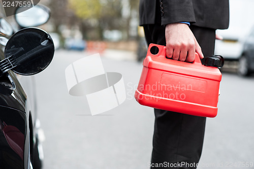 Image of Man holding fuel can, cropped image