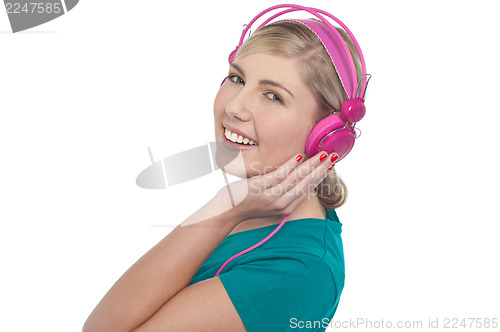 Image of Blonde teen listening to music