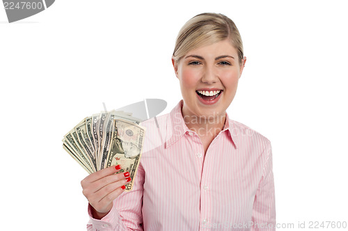 Image of Excited girl holding currency notes fan