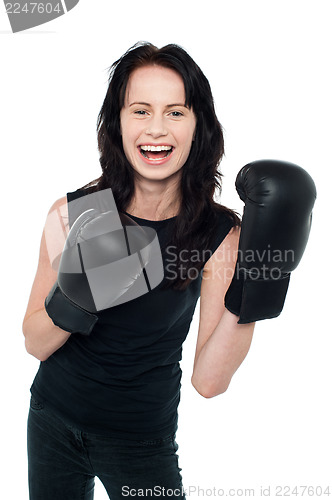 Image of Smiling young slim female boxer
