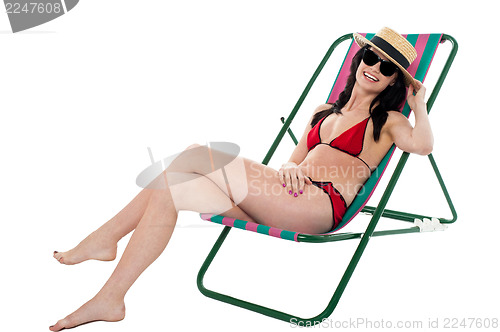 Image of Young bikini woman relaxing on deckchair