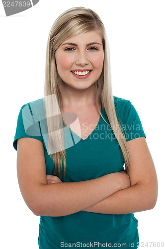 Image of Cheerful pretty girl in casuals posing with folded arms