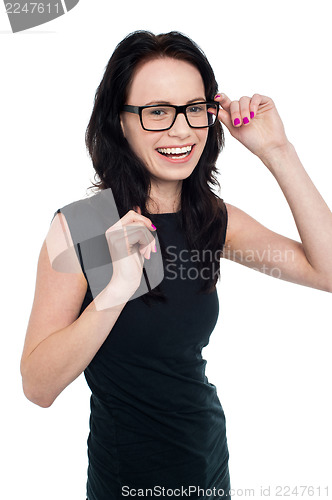 Image of Charming smiling lady adjusting her eyeglasses